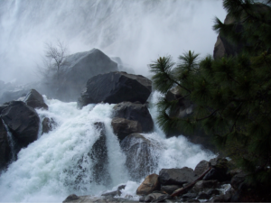 cascading water in rocks below falls